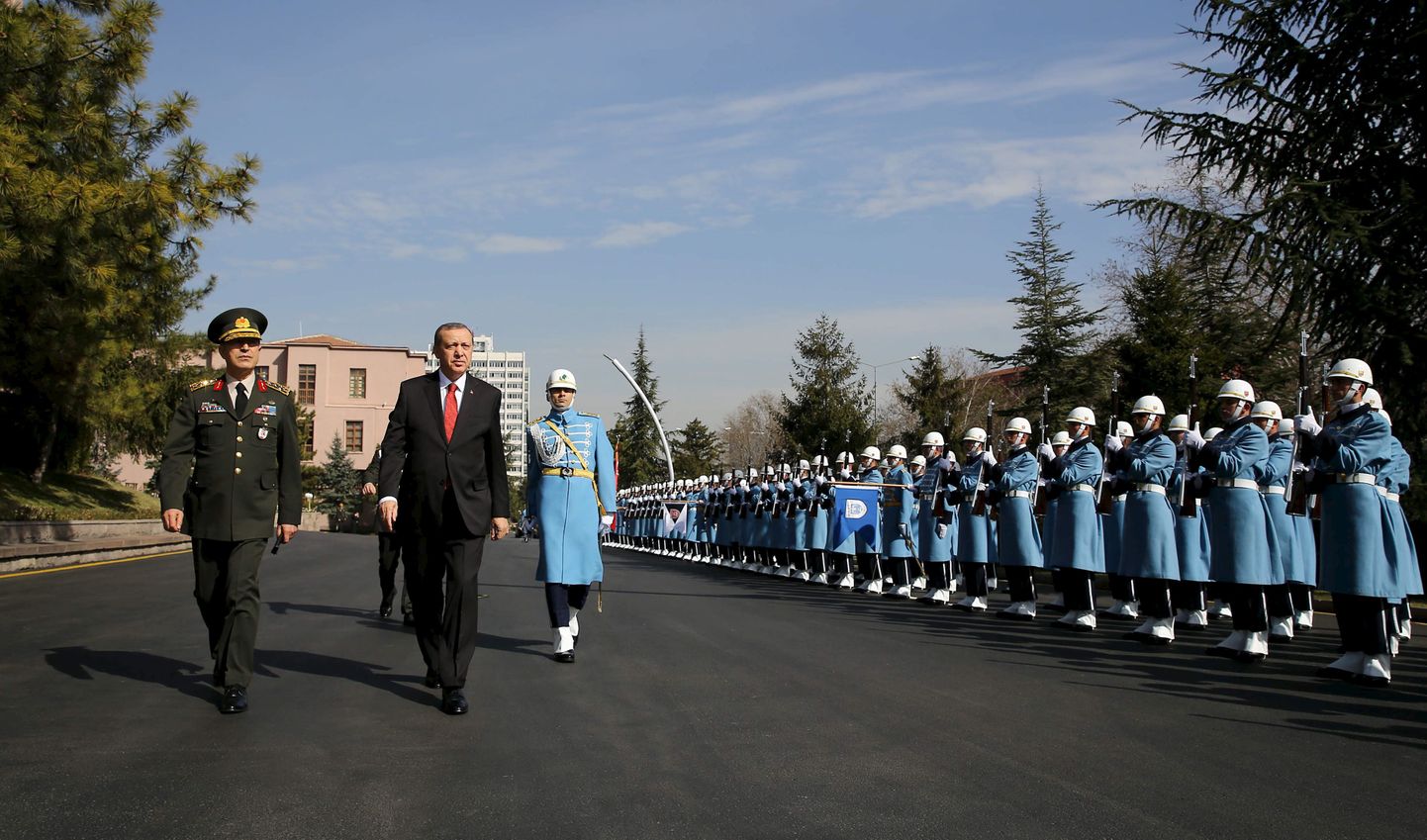 Turkish President Tayyip Erdogan (2nd L), flanked by Chief of Staff General Hulusi Akar, reviews a guard of honour as he arrives the Army headquarters in Ankara, Turkey February 18, 2016, in this handout photo provided by the Presidential Palace. REUTERS/Yasin Bulbul/Presidential Palace/Handout via Reuters ATTENTION EDITORS - THIS IMAGE WAS PROVIDED BY A THIRD PARTY. REUTERS IS UNABLE TO INDEPENDENTLY VERIFY THE AUTHENTICITY, CONTENT, LOCATION OR DATE OF THIS IMAGE. FOR EDITORIAL USE ONLY. NOT FOR SALE FOR MARKETING OR ADVERTISING CAMPAIGNS. FOR EDITORIAL USE ONLY. NO RESALES. NO ARCHIVE. THE PICTURE IS DISTRIBUTED EXACTLY AS RECEIVED BY REUTERS, AS A SERVICE TO CLIENTS.