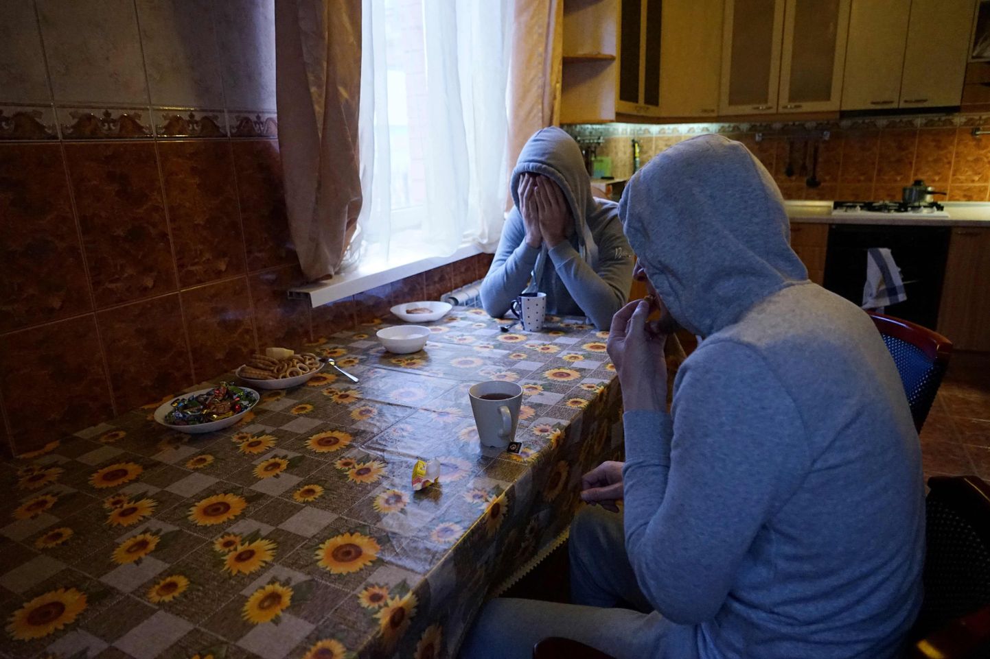 Chechen gay men who fled persecution in their home Russia's Muslim region of Chechnya due to his sexual-orientation, sits around a table in their flat in Moscow on April 17, 2017. / AFP PHOTO / Naira DAVLASHYAN / TO GO WITH AFP STORY BY Anais LLOBET