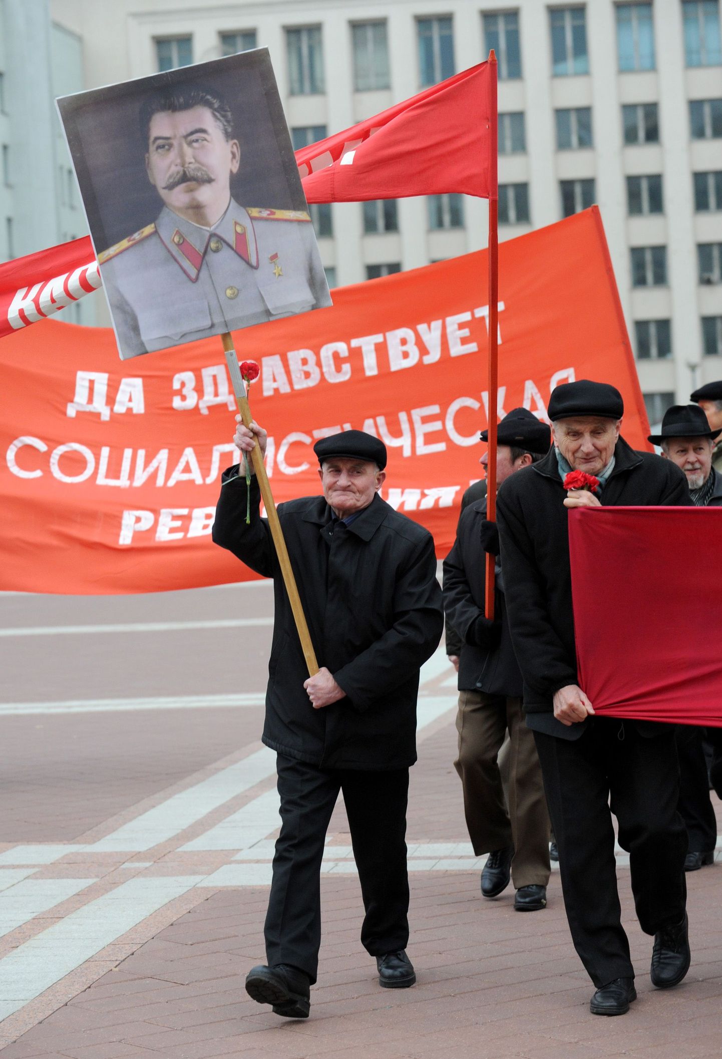 Members of Belarus Communist Party carry a portrait of Soviet dictator Josef Stalin in Minsk, on November 7, 2012, as they rally to mark the 95th anniversary of the October 1917 Bolshevik Revolution.  AFP PHOTO / VIKTOR DRACHEV