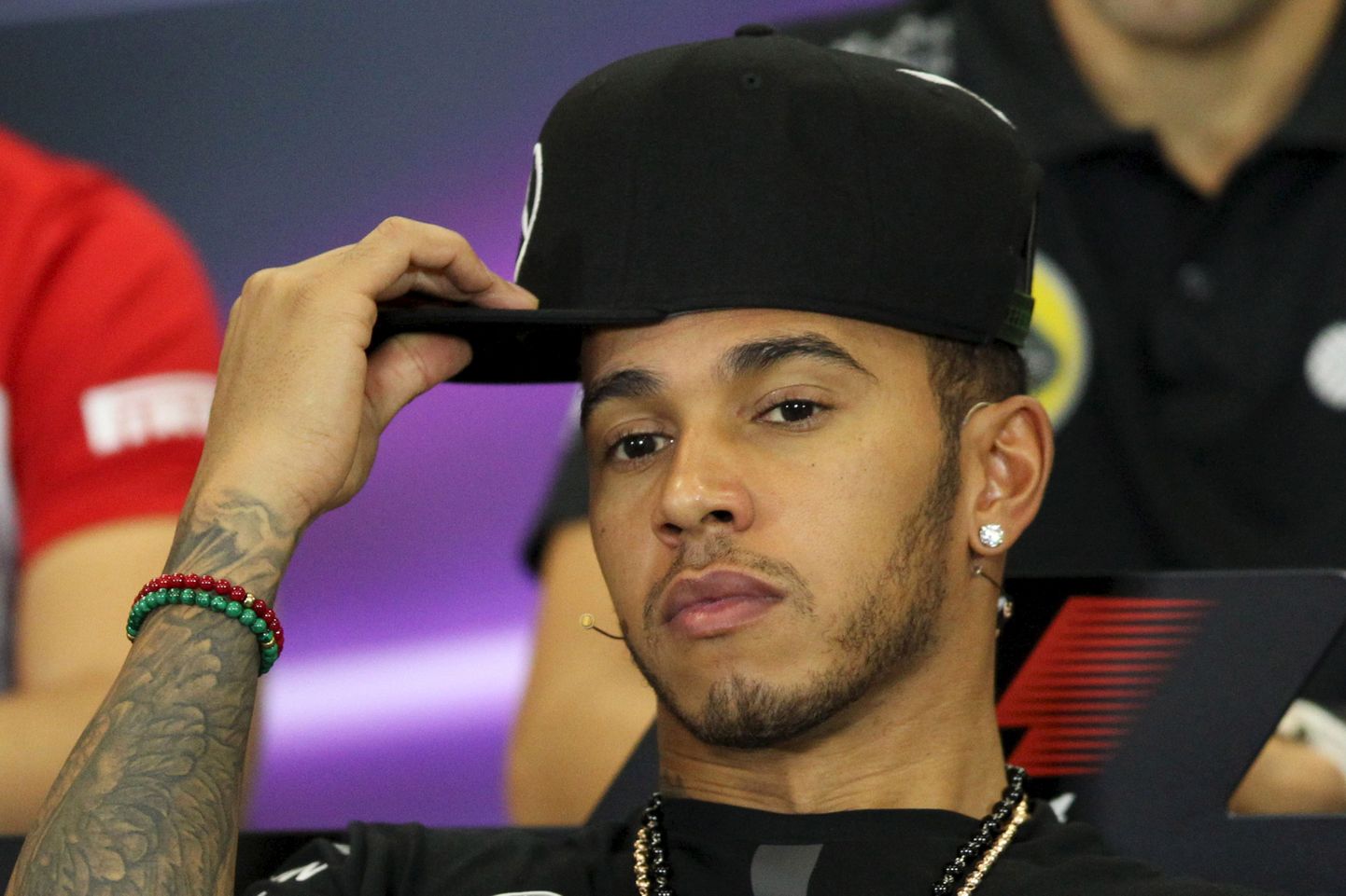 Mercedes Formula One driver Lewis Hamilton of Britain adjusts his cap during a news conference before Mexican F1 Grand Prix at Autodromo Hermanos Rodriguez in Mexico City, October 29, 2015. REUTERS/Edgard Garrido