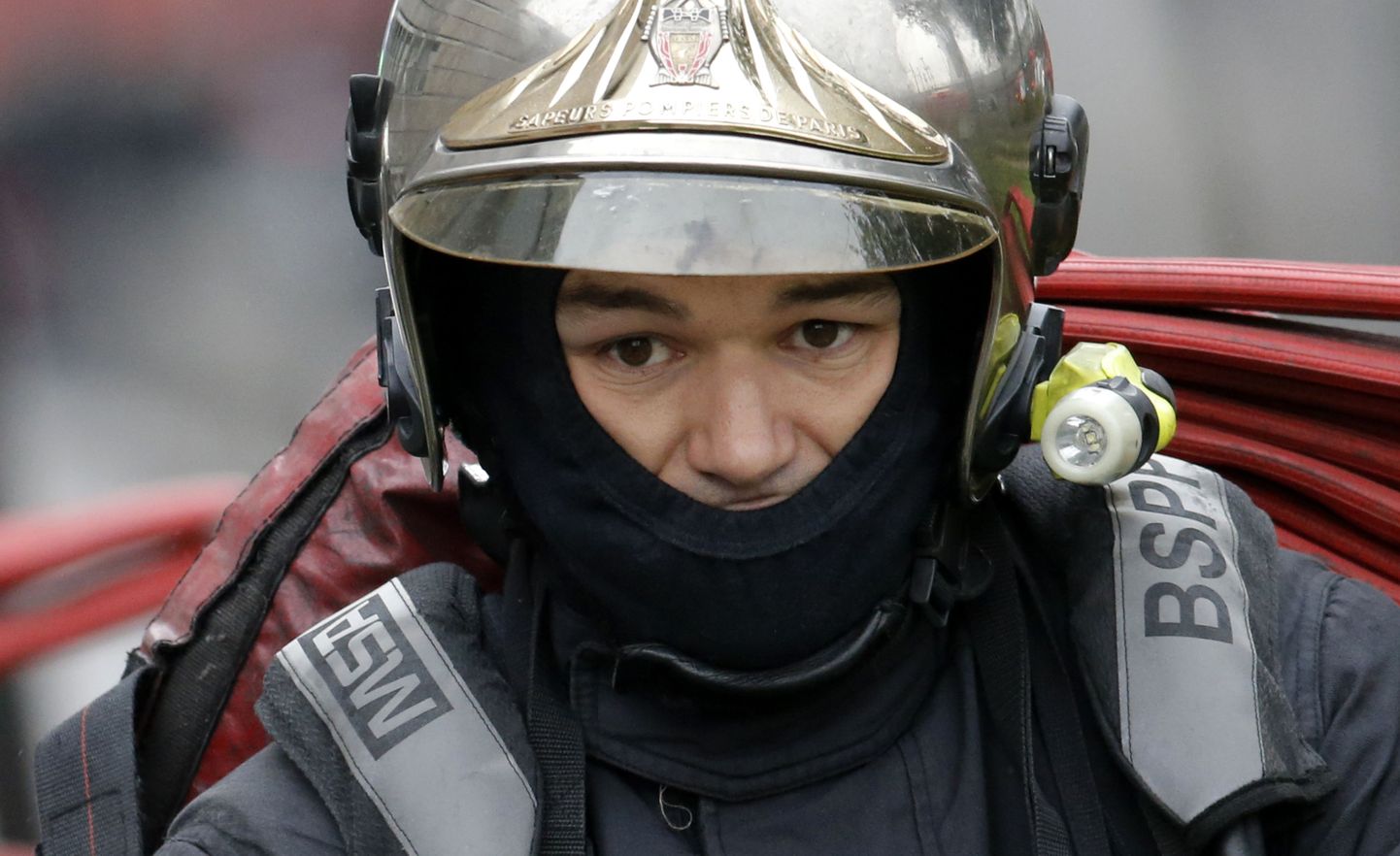 A French firefighter of Paris Fire Brigade (BSPP) is seen on site of the fire that broke-out overnight at the Cite des Sciences et Industries Museum at La Villette, in Paris, France, August 20, 2015. More than 10,000 square meters were hit by the fire that started in an area under construction. REUTERS/Christian Hartmann
