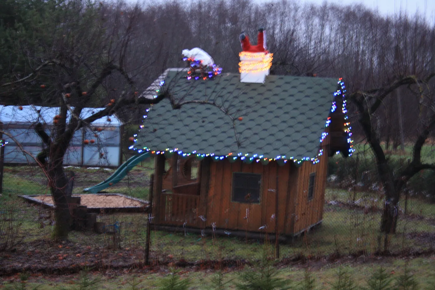 Lustakas jõulukaunistus ühe Jõgeva aiamaja juures, kus jõuluvana on kingikoti katusele sättinud ja ise peadpidi korstnasse sukeldudes kinni jäänud.