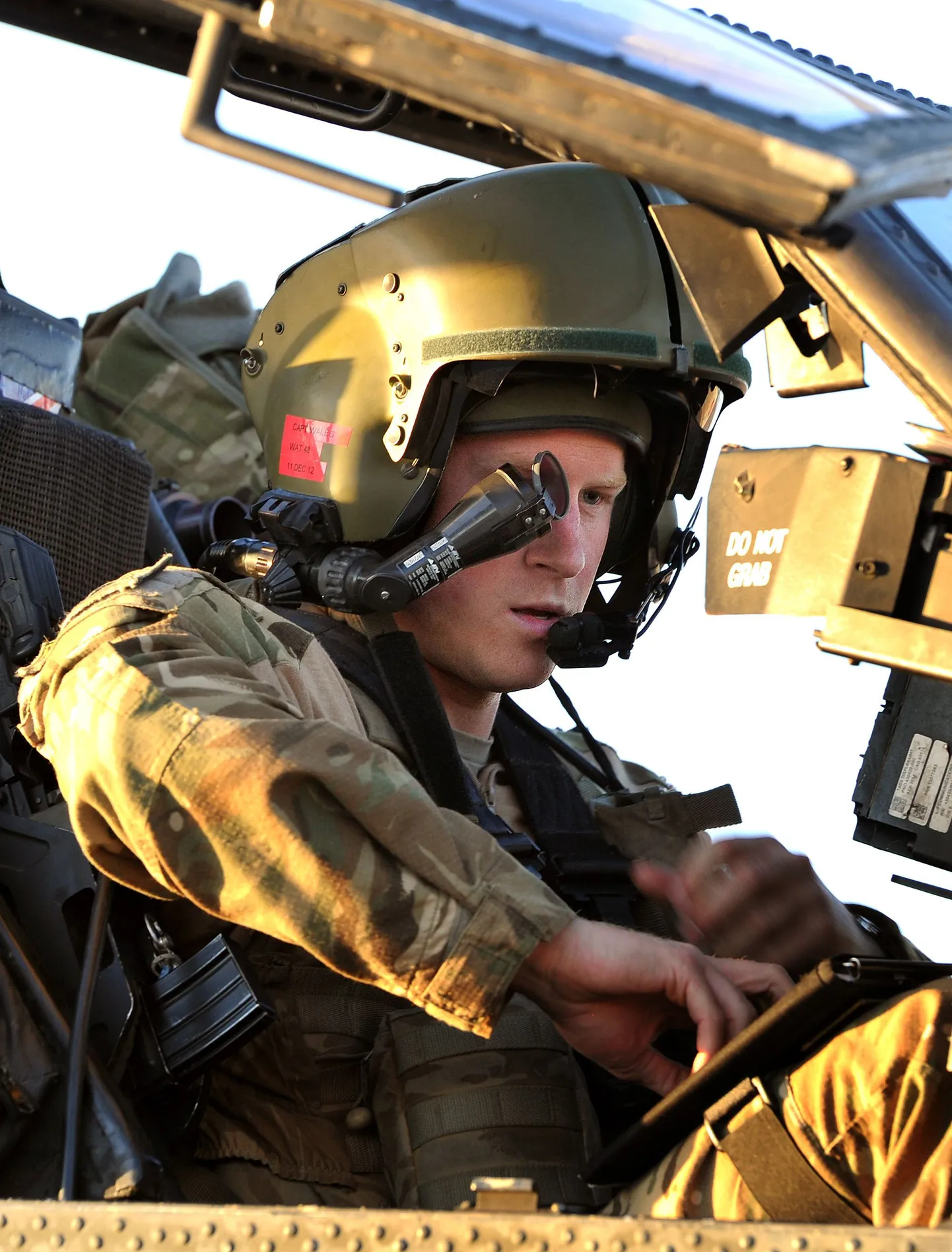 This picture taken on November 2, 2012 shows Britain's Prince Harry wearing his monocle gun sight as he sits in the front seat of his Apache Helicopter at the British controlled flight-line at Camp Bastion in Afghanistan's Helmand Province, where he was serving as an Apache Helicopter Pilot/Gunner with 662 Sqd Army Air Corps. Britain's Prince Harry confirmed he killed Taliban fighters during his stint as a helicopter gunner in Afghanistan, it can be reported after he completed his tour of duty on January 21, 2013.  AFP PHOTO / POOL / JOHN STILLWELL