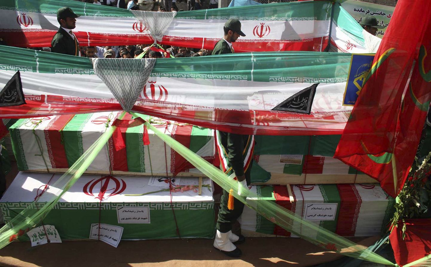Iraani lippudesse mähitud kirstud pühapäevase suitsiidirünnaku ohvrite surnukehadega.