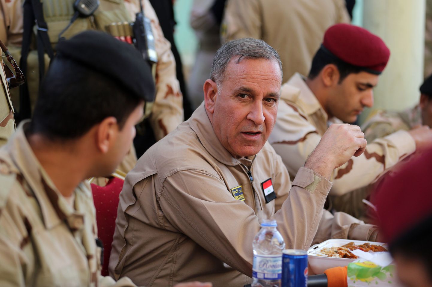 Iraqi Defense Minister Khalid al-Obeidi,  center, speaks to his soldiers at a military base in Tikrit, 80 miles (130 kilometers) north of Baghdad, Iraq, Monday, Dec. 8, 2014. The commander of U.S. forces fighting the Islamic State in Iraq and Syria, Army Lt. Gen. James Terry says the extremist group has been thrown on the defensive, because coalition airstrikes and other measures are taking a toll on IS ability to communicate. (AP Photo/Hadi Mizban)