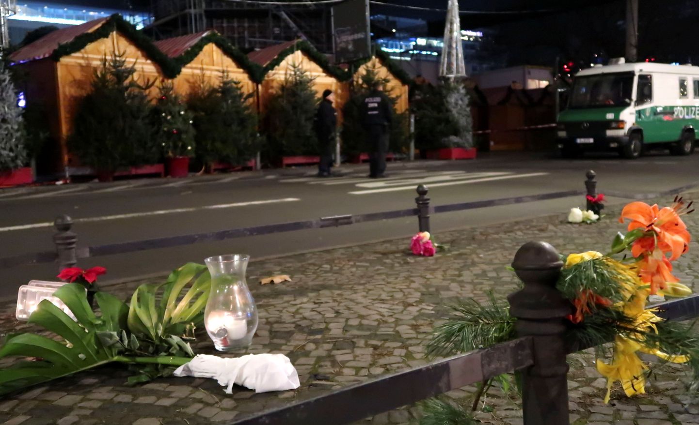 Люди приносят цветы на место теракта в Берлине.