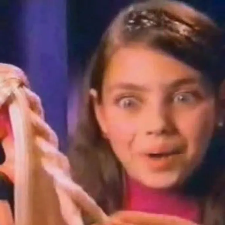 Mila Kunisa Bārbijas reklāmā apbrīno lelli. 