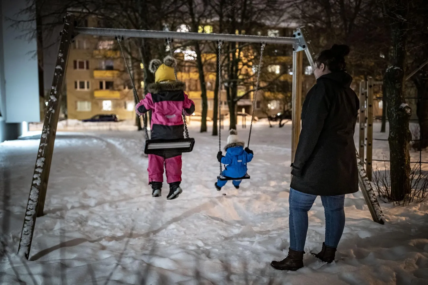 Fotolavastus: üksikema lastega mänguväljakul.