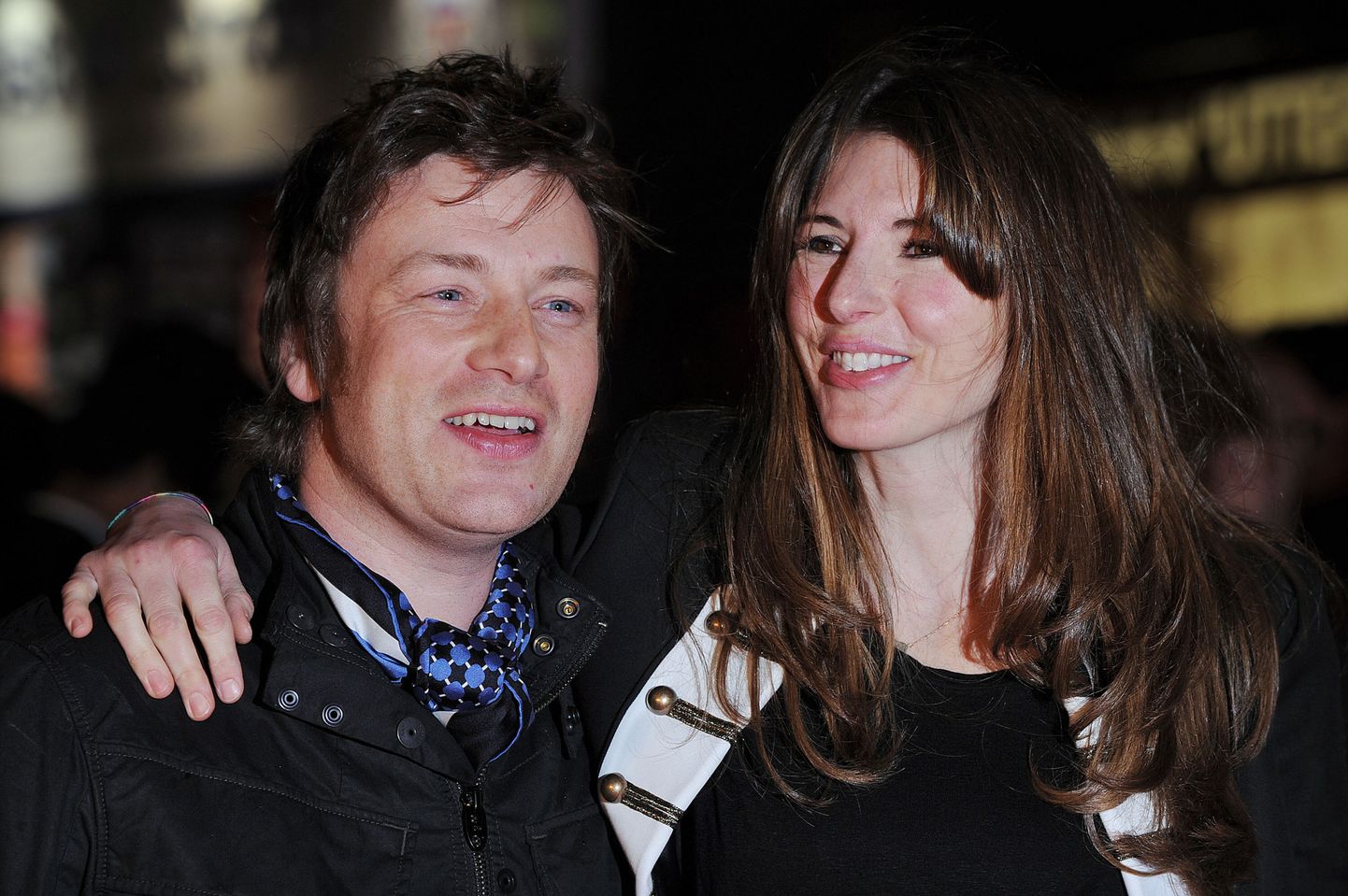 British chef Jamie Oliver (L) and his wife Jools smile as they arrive to the European premiere of new movie "Kick-Ass" in London on March 22, 2010.  AFP PHOTO/ BEN STANSALL
