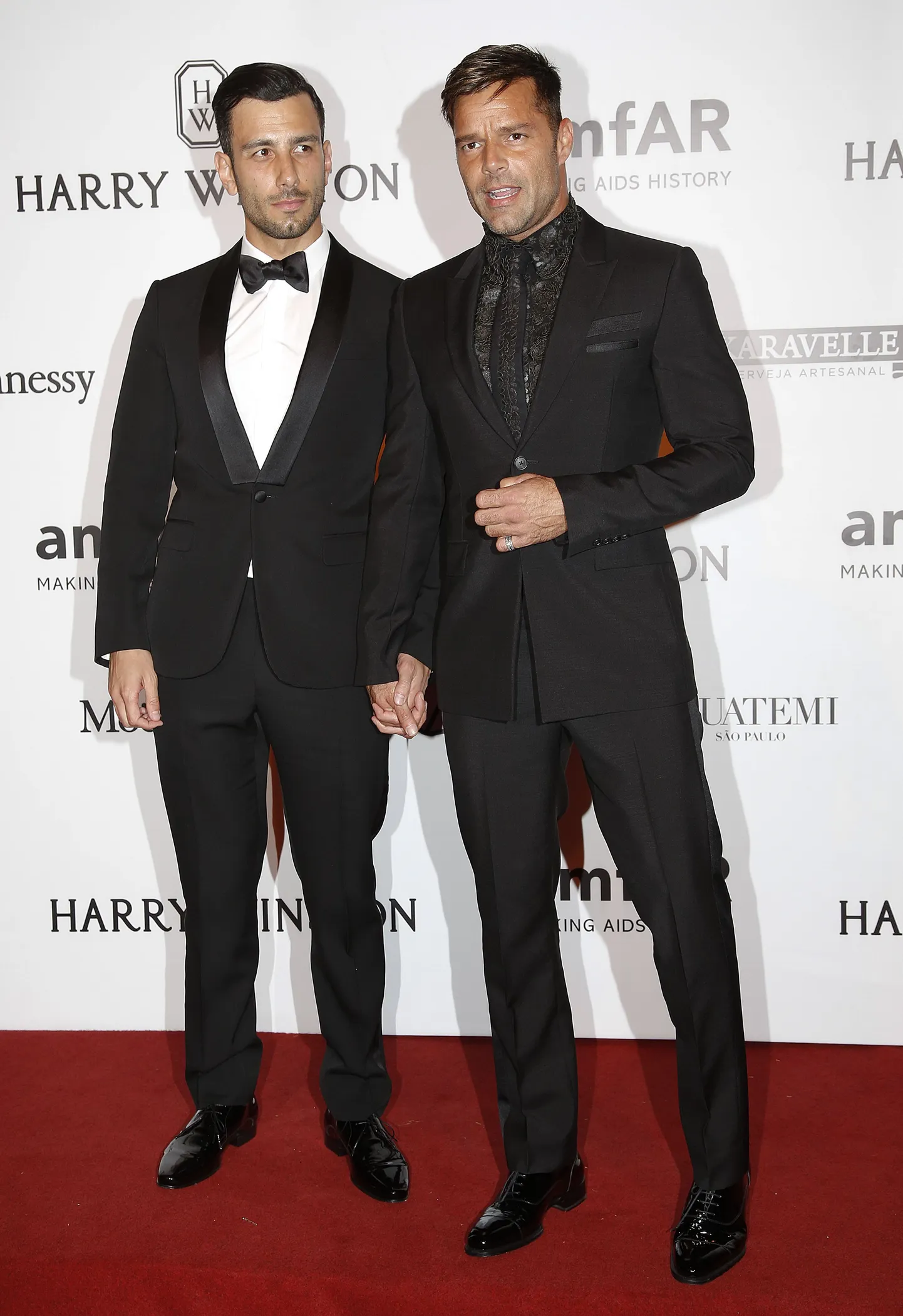 Singer Ricky Martin, right, and artist Jwan Yosef pose on the red carpet of The Foundation for AIDS Research (amfAR) event in Sao Paulo, Brazil, Friday, April 15, 2016. (AP Photo/Andre Penner)
