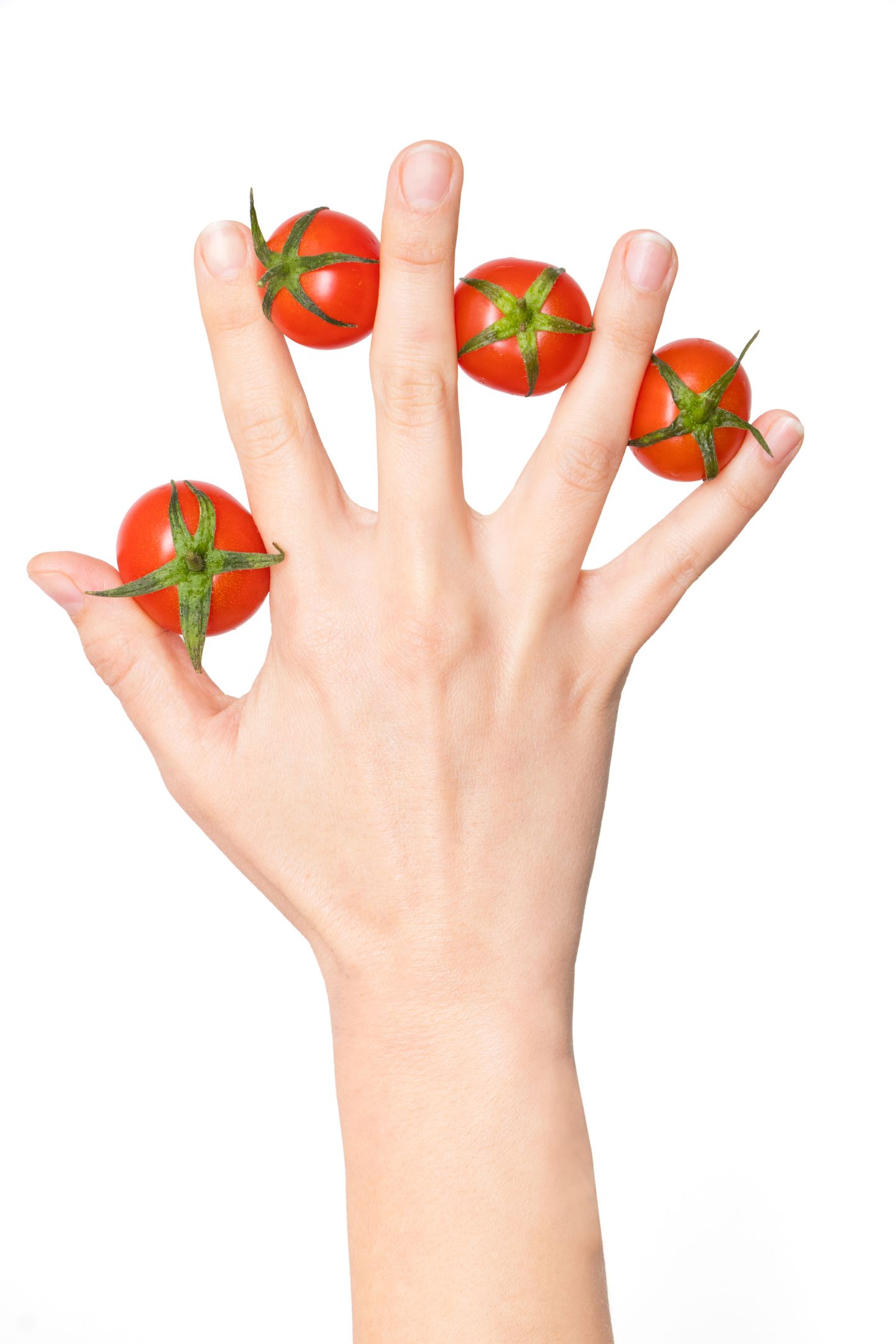 Woman hand with tomatoes between her fingers