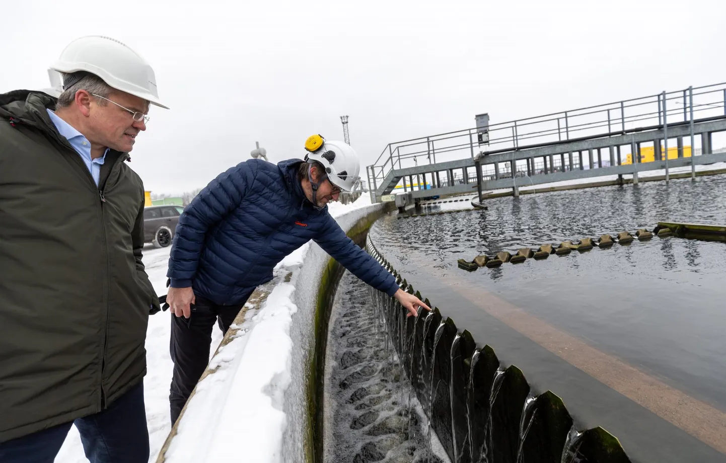 Tartu Veevärgi juhataja Toomas Kapp (vasakul) ja Greni Eesti äride juht peavad plaani reovee soojust linna kütteks rakendada. Margo Külaots veendus oma käega järele proovides, et reoveepuhasti vesi on soe ka talvel.