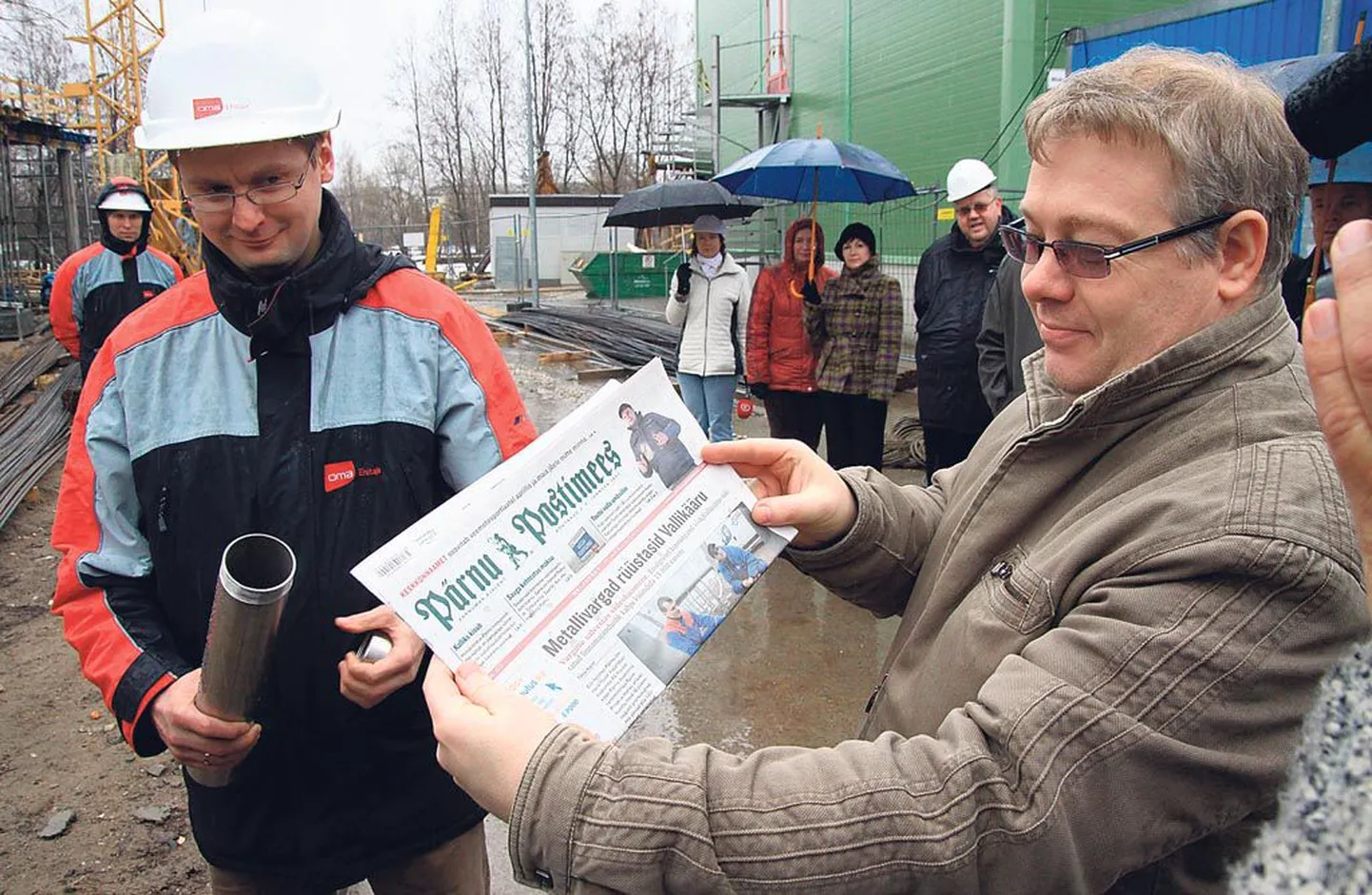 Auto- ja metallitöökoja hoone nurgakivi kapslisse asetasid AS Oma Ehitaja projektijuht Jaanus Erm (vasakul) ja Pärnumaa kutsehariduskeskuse projektijuht Andrus Simberg tavakohaselt samal päeval ilmunud kohaliku lehe.
