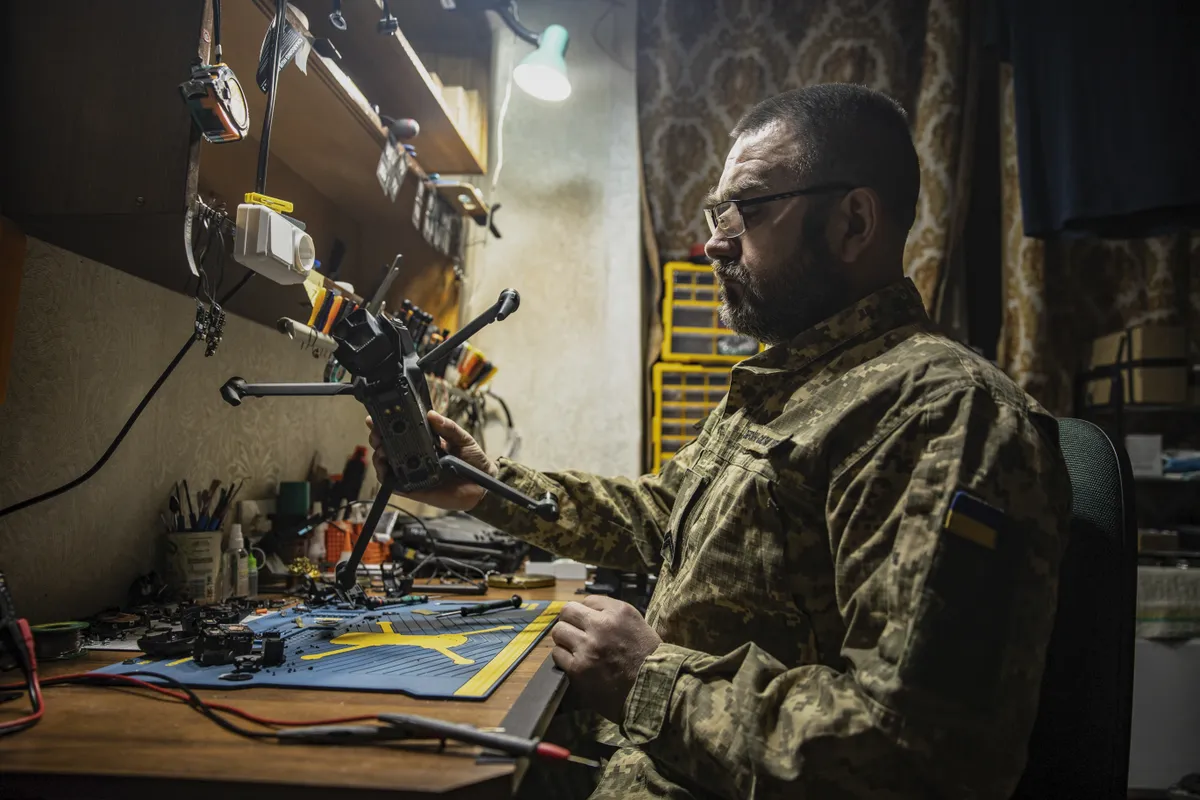 A Ukrainian soldier repairs an FPV drone at a frontline workshop near Siversk, Donetsk Oblast, Ukraine.