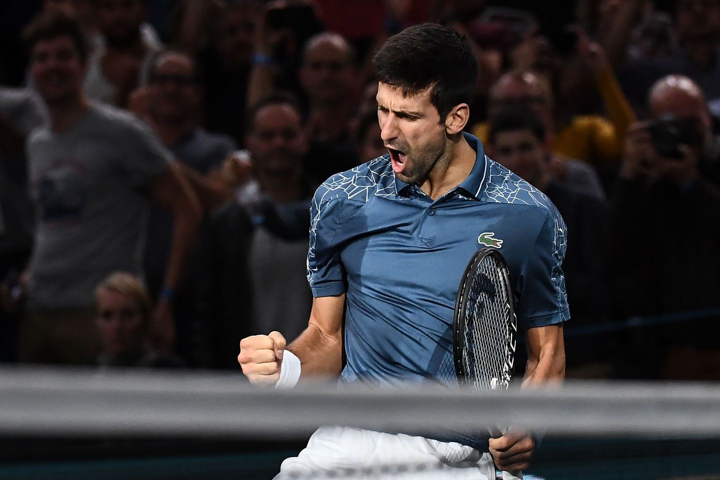 Serbia's Novak Djokovic celebrates after winning against Switzerland's Roger Federer at the end of their men's singles semi-final tennis match on day six of the ATP World Tour Masters 1000 - Rolex Paris Masters - indoor tennis tournament at The AccorHotels Arena in Paris, on November 3, 2018. (Photo by Anne-Christine POUJOULAT / AFP)