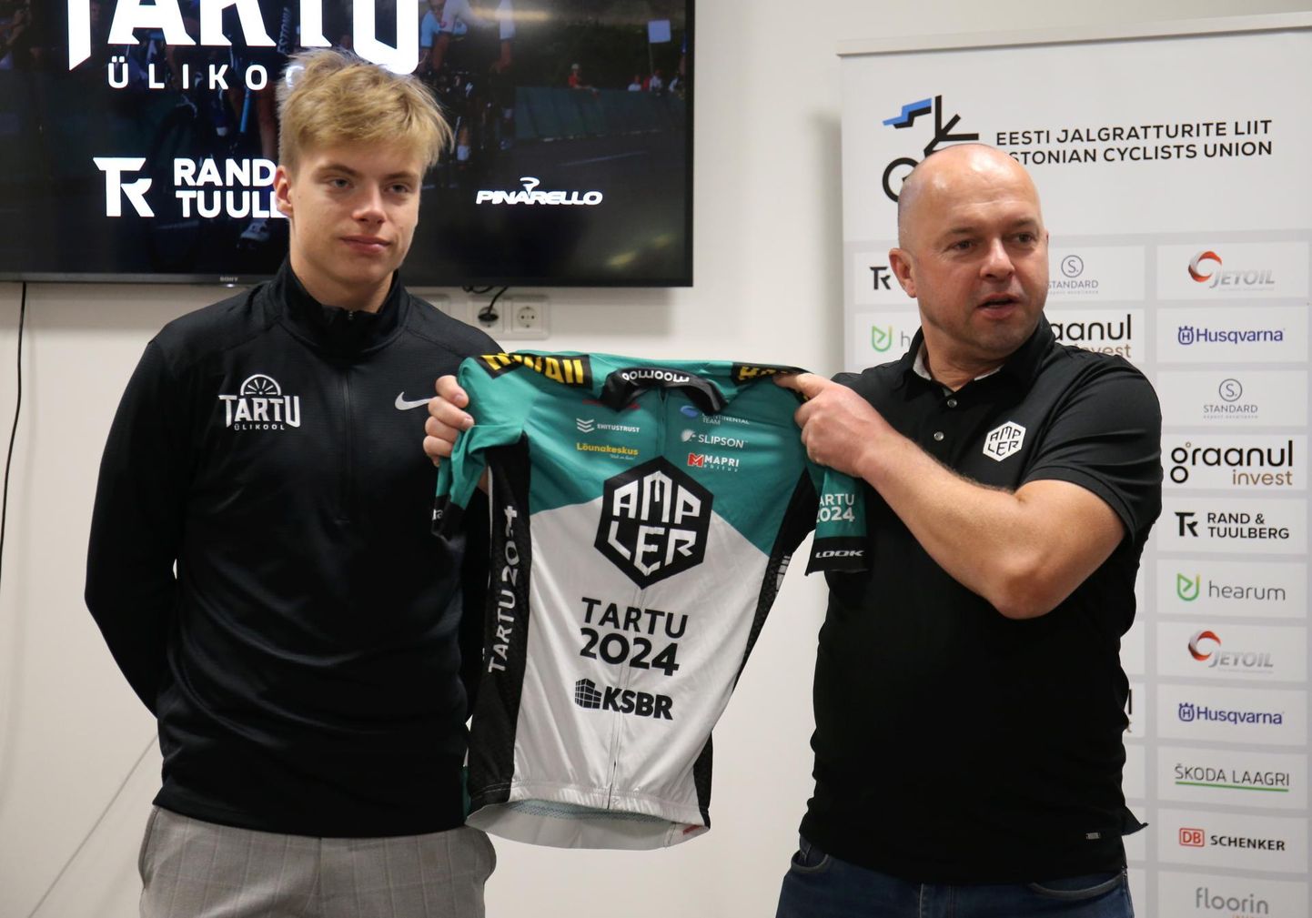 Tartu 2024 ratta­tiimi spordidirektor Jaan Kirsipuu andis Madis Mihkelsile (va­sakul) üle uue meeskonna vormi, küll veel selle hooaja oma.
 