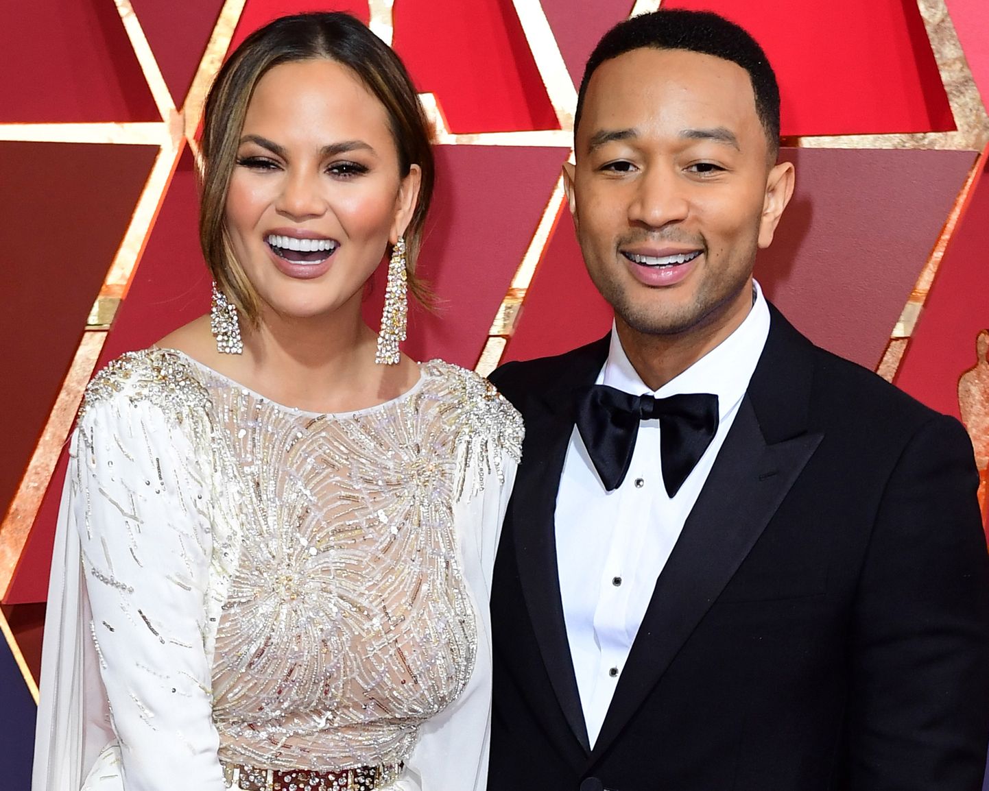File photo dated 26/02/17 of Chrissy Teigen and John Legend, as Chrissy has scolded her husband for taking all of her phone chargers.