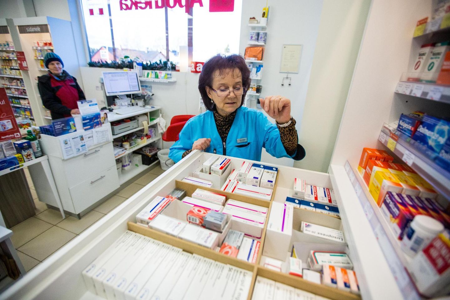 Lilleoru apteegi farmatseut Eve Urbas püüab kliendile sobivat ravimit leida.