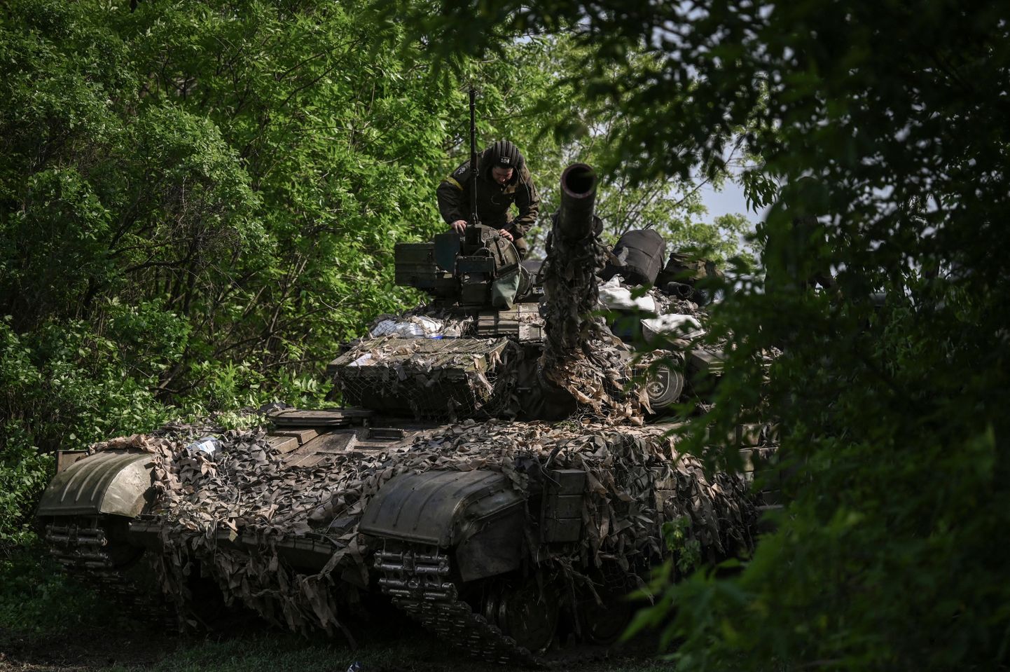 Ukraiņu karavīrs uzrauga tanku frontes līnijas pozīcijā netālu no Lisičanskas pilsētas, Ukrainas austrumos