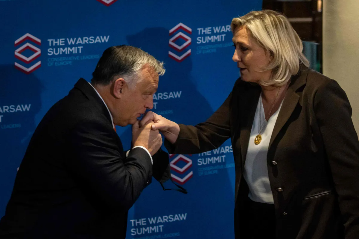 Leader of French far-right party Rassemblement National (RN) and candidate for the French presidential elections Marine Le Pen (R) and Hungarian Prime Minister Viktor Orban (L) pose before the meeting of Leaders of European conservative and right-wing parties 'The Warsaw Summit' in Warsaw, Poland, on December 4, 2021.
