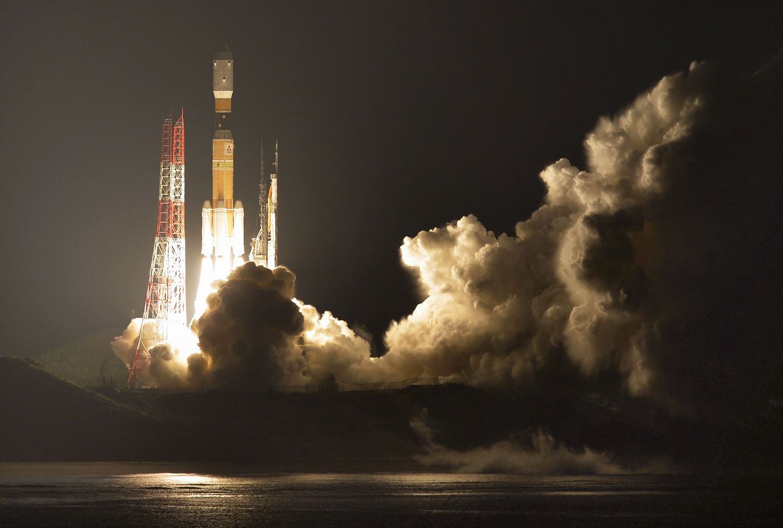 Japan's H-IIB rocket with a capsule called Kounotori, or stork, lifts off at the Tanegashima Space Center in Tanegashima, southern Japan, Friday evening, Dec. 9, 2016. The Japanese capsule contains nearly 5 tons of food, water and other supplies, including new lithium-ion batteries for the International Space Station