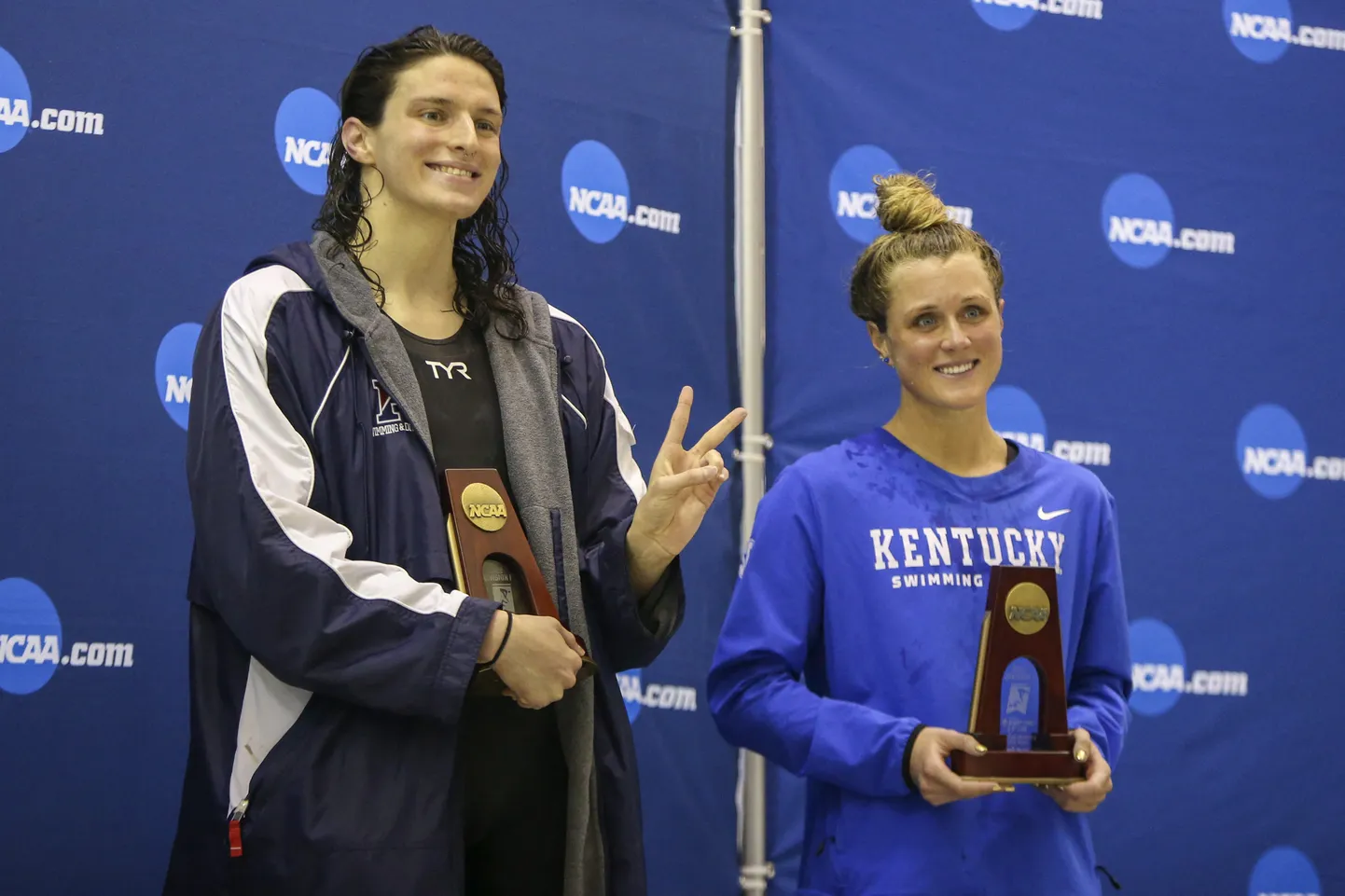 Mar 18, 2022; Atlanta, Georgia, USA; Penn Quakers swimmer Lia Thomas holds a trophy after finishing fifth in the 200 free at the NCAA Swimming & Diving Championships as Kentucky Wildcats swimmer Riley Gaines looks on at Georgia Tech. Mandatory Credit: Brett Davis-USA TODAY Sports