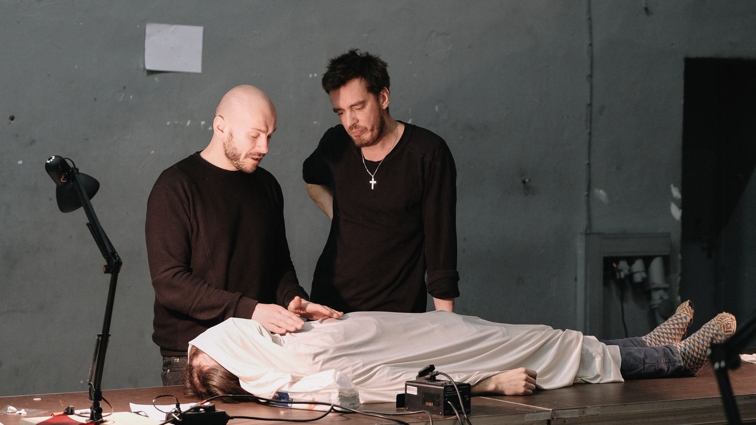 Mart Kangro ja Juhan Ulfsak õpetavad, kuidas laibaga hakkama saada. Surnukeha mängib Eero Epner. Hetk lavastusest «Workshop».
