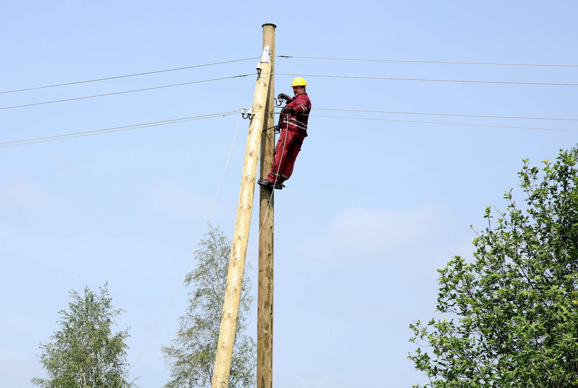 AS "Sadales tīkls" darbinieks atjauno elektroapgādi Jaunsātu pagastā, kur otrdienas vakarā plosījās vētra.