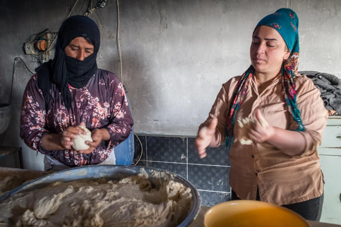 Jinwari elanikud Watha ja Dicle valmistavad küla pagarikojas leivatainast. Leiba müüakse nii pisikeses kogukonnapoes kui ka mitmes naaberkülas.