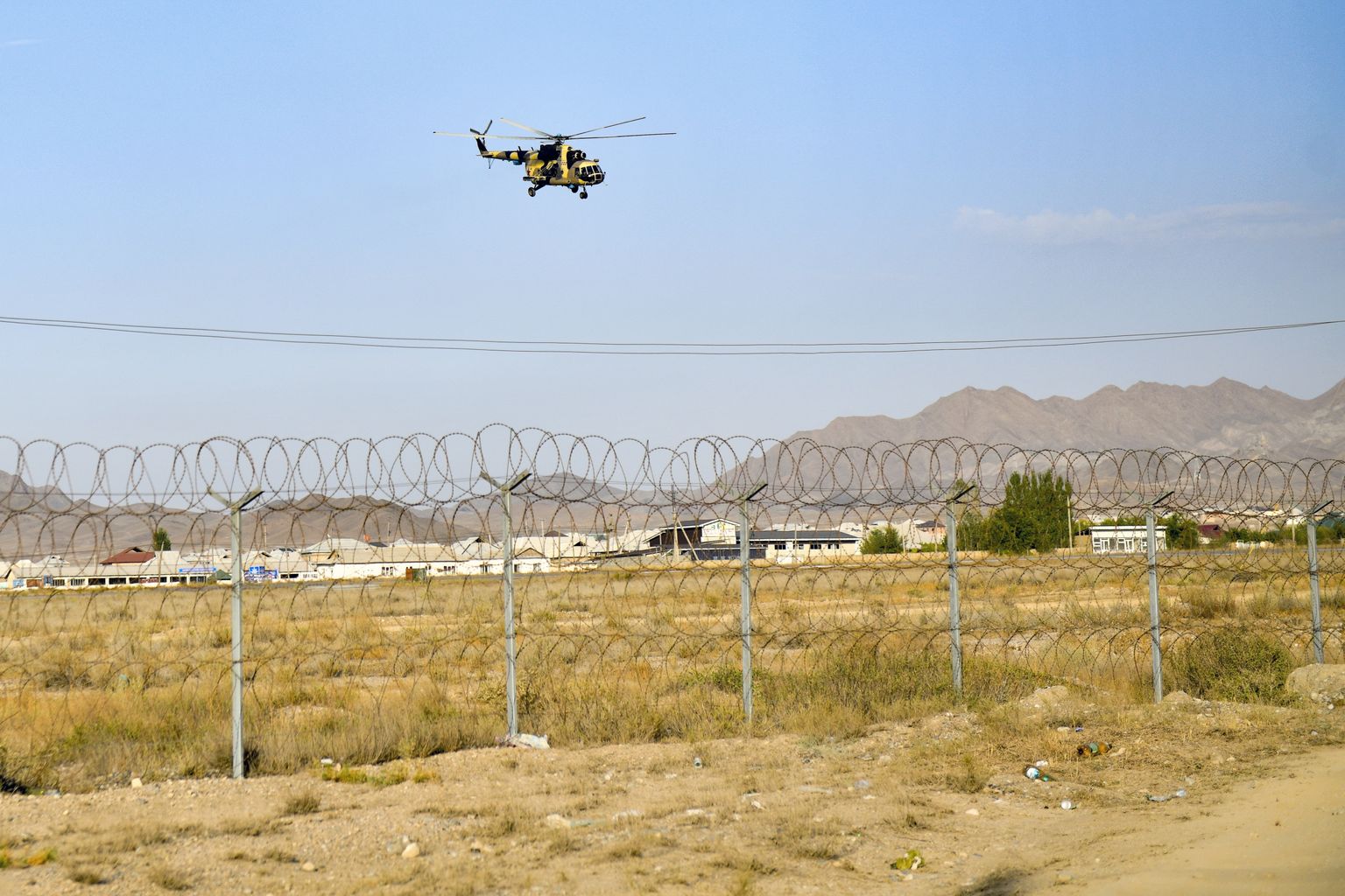 Военный вертолет пролетает над кыргызско-таджикской границей возле Баткена, юго-запада Кыргызстана, в субботу, 17 сентября.