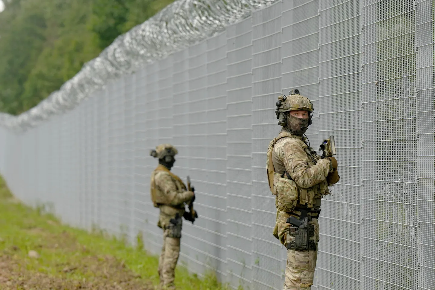 Latvian Border Guard special unit officers patrol along the fence at Latvia-Belarus border near Robeznieki, Latvia August 8, 2023.