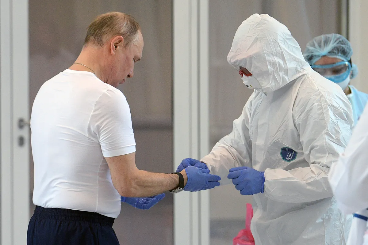 MOSCOW, RUSSIA - MARCH 24, 2020: Russia's President Vladimir Putin [or one of his body doubles] takes off his protective suit on his visit to the Novomoskovsky multipurpose medical center for patients suspected of the COVID-19 coronavirus infection.