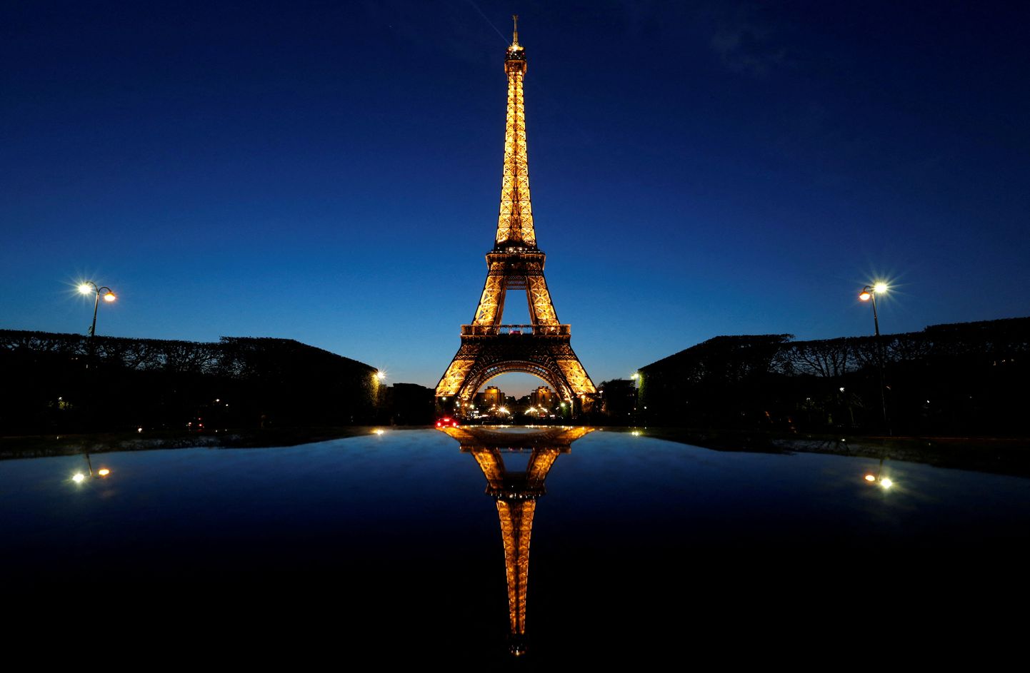 FILE PHOTO: A night view shows the Eiffel tower, reflected in a car's roof, in Paris, France, April 30, 2016. REUTERS/Christian Hartmann/File Photo