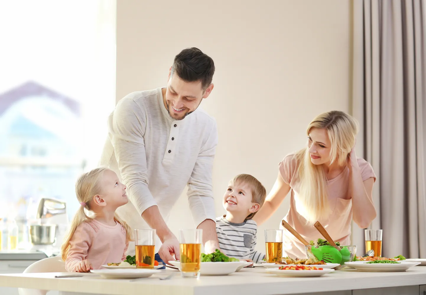 Happy family having breakfast at home