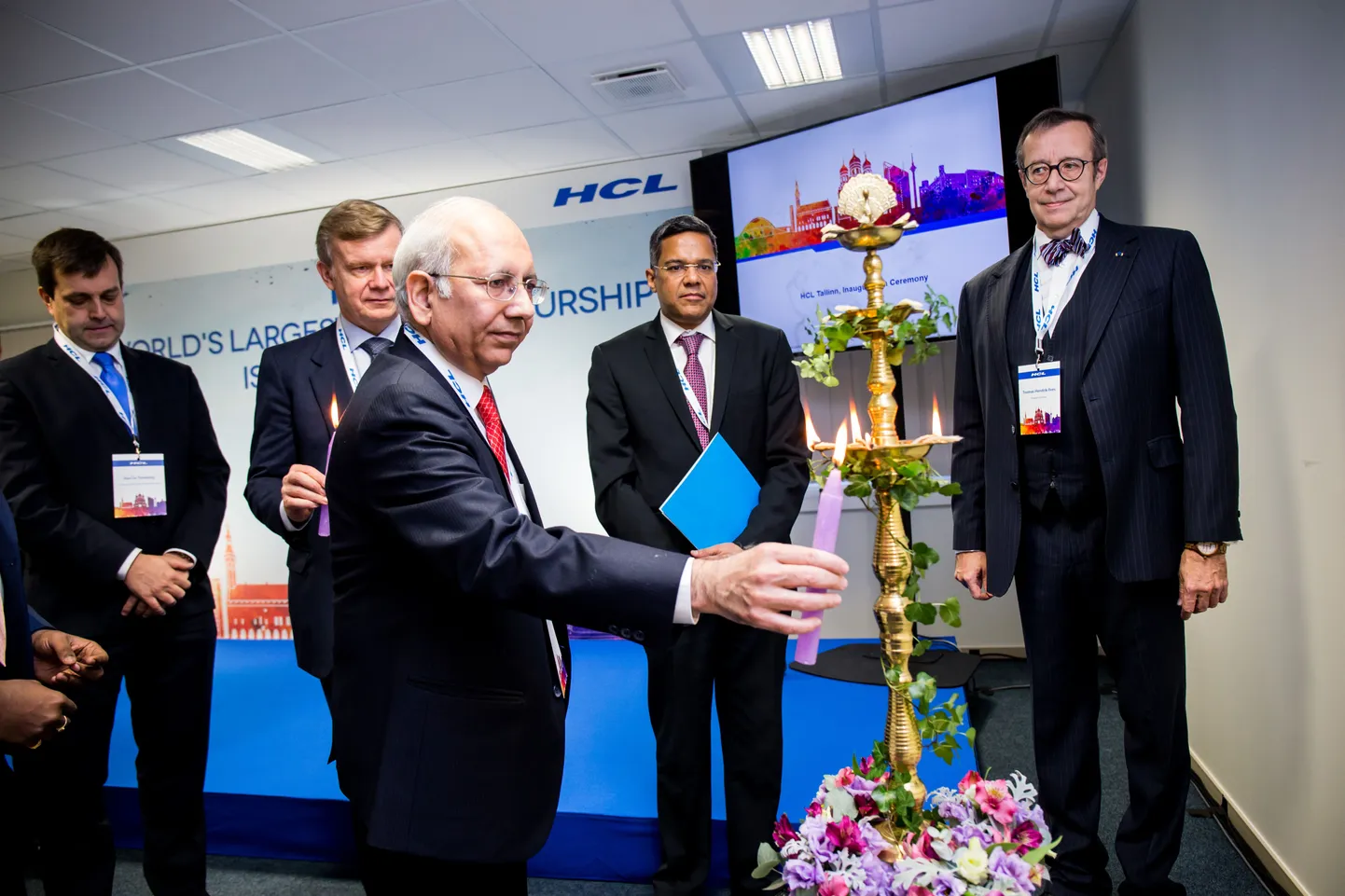 2015. aasta detsember: HCLi Eesti kontorit Ülemistel avavad India suursaadik Eestis Ashok Kumar Sharma (esiplaanil) ja president Toomas Hendrik Ilves (paremal), nende vahel seisab HCLi finantsteenuste president Rahul Singh.