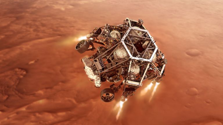 Марсоход Perseverance приземляется к поверхности Марса.