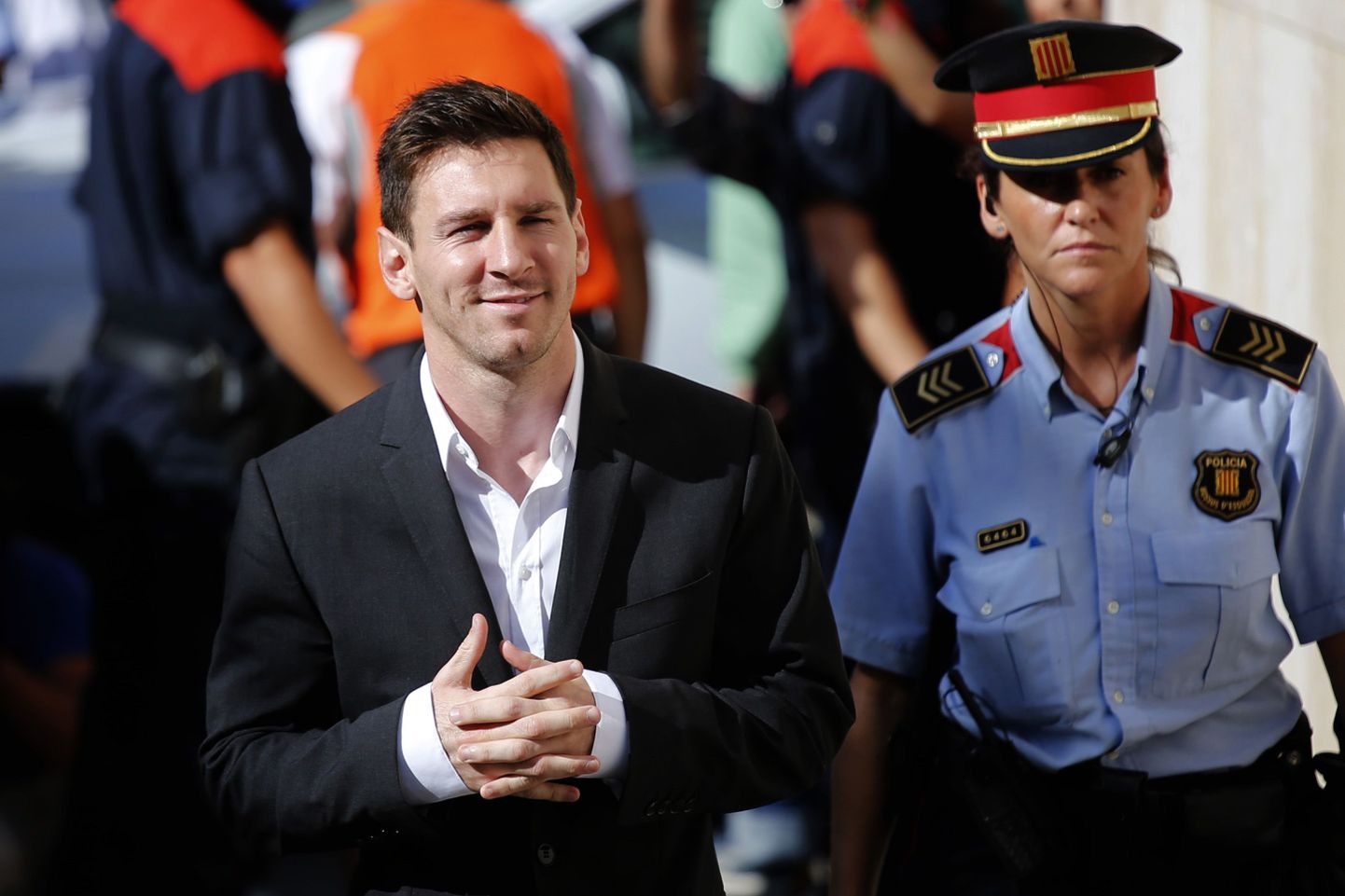 FILE - In this Sept. 27, 2013 file photo, FC Barcelona star Lionel Messi, left, arrives at a court to answer questions in a tax fraud case in Gava, near Barcelona, Spain. Lionel Messi will stand trial in Spain on three counts of tax fraud and could be sentenced to nearly two years in prison if found guilty. Court documents made public Thursday said a judge has rejected a request to clear the Barcelona player of wrongdoing and decided to charge him and his father, Jorge Horacio Messi, with tax fraud. (AP Photo/Emilio Morenatti, File)