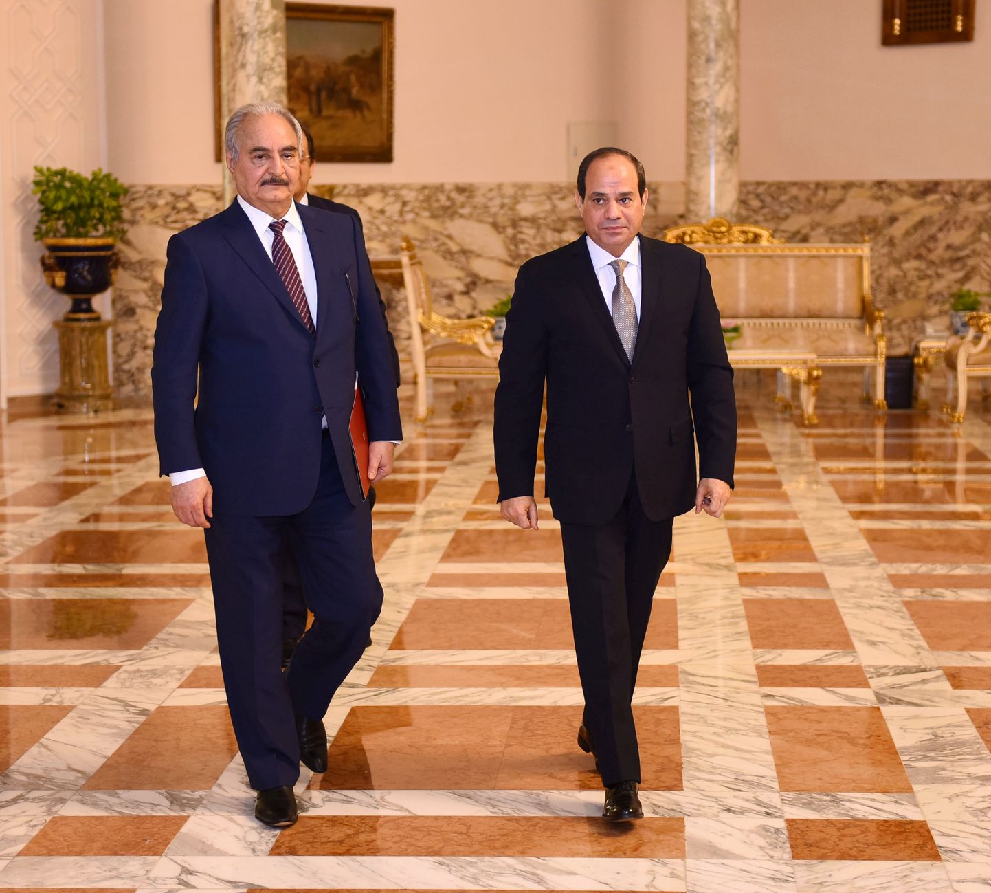 Libyan military commander Khalifa Haftar walks with Egyptian President Abdel Fattah al-Sisi at the Presidential Palace in Cairo, Egypt April 14, 2019 in this handout picture courtesy of the Egyptian Presidency. The Egyptian Presidency/Handout via REUTERS ATTENTION EDITORS - THIS IMAGE WAS PROVIDED BY A THIRD PARTY.