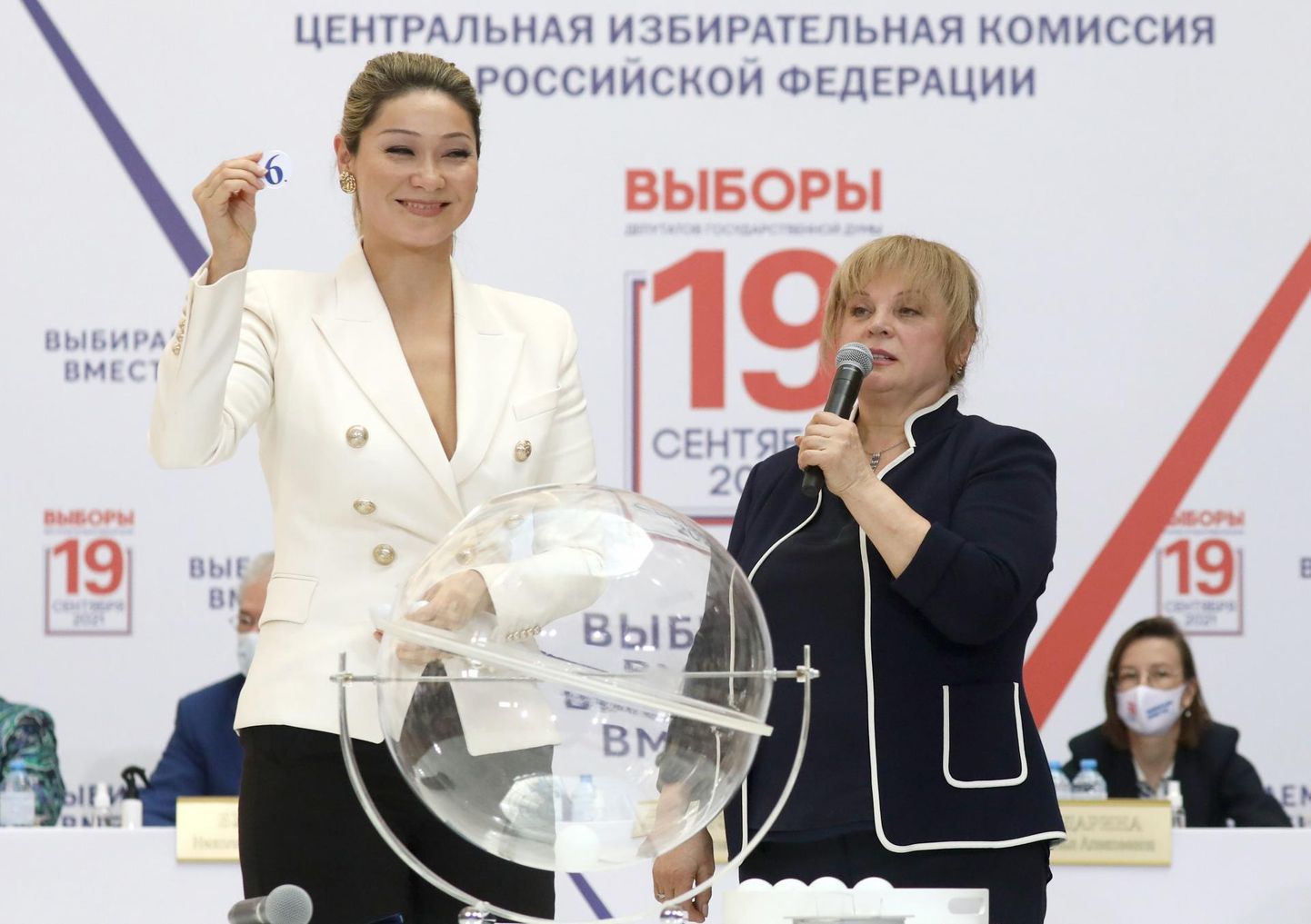 Telesaatejuht Marina Kim (vasakul) ja keskvalimiskomisjoni juht Ella Pamfilova loosimisel, kus selgitati välja riigiduuma valimistel osalevate erakondade järjekord valimissedelitel. 