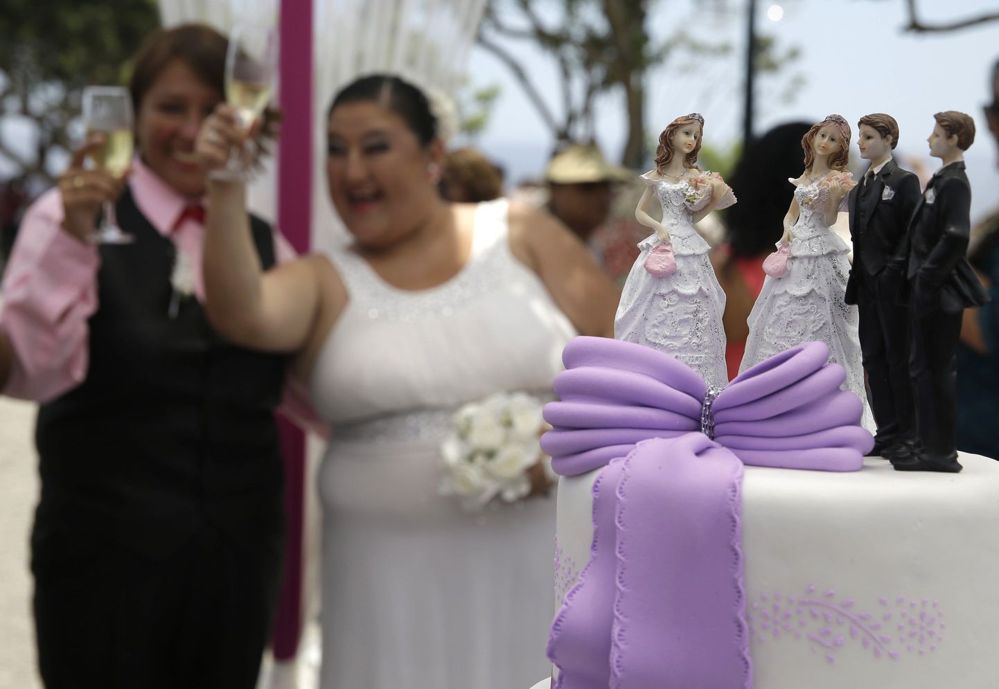 Members of the Lesbian, Gay, Transexual and Bisexual, LGTB, community, Marleni, right, and Diana make a toast after their symbolic marriage on Valentine's Day in Lima, Peru, Tuesday, Feb. 14, 2017. About 10 couples of the LGTB community attended a symbolic marriages ceremony to demand equal rights. (AP Photo/Martin Mejia)