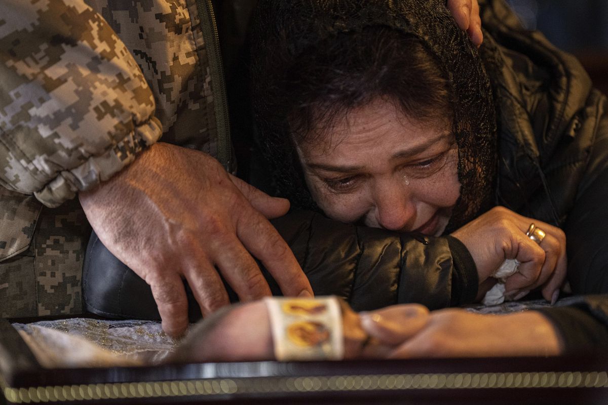 Лилия плачет над телом своего сына - старшего лейтенанта ВСУ Антона Зайца, который погиб в бою за Бахмут. 27 марта 2023 года. (AP Photo/Evgeniy Maloletka) MAL102