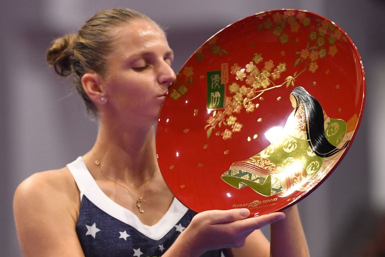 Karolina Pliskova of the Czech Republic kisses her trophy after beating Japan's Naomi Osaka in their women's singles final at the Pan Pacific Open tennis tournament in Tokyo on September 23, 2018. (Photo by Toshifumi KITAMURA / AFP)