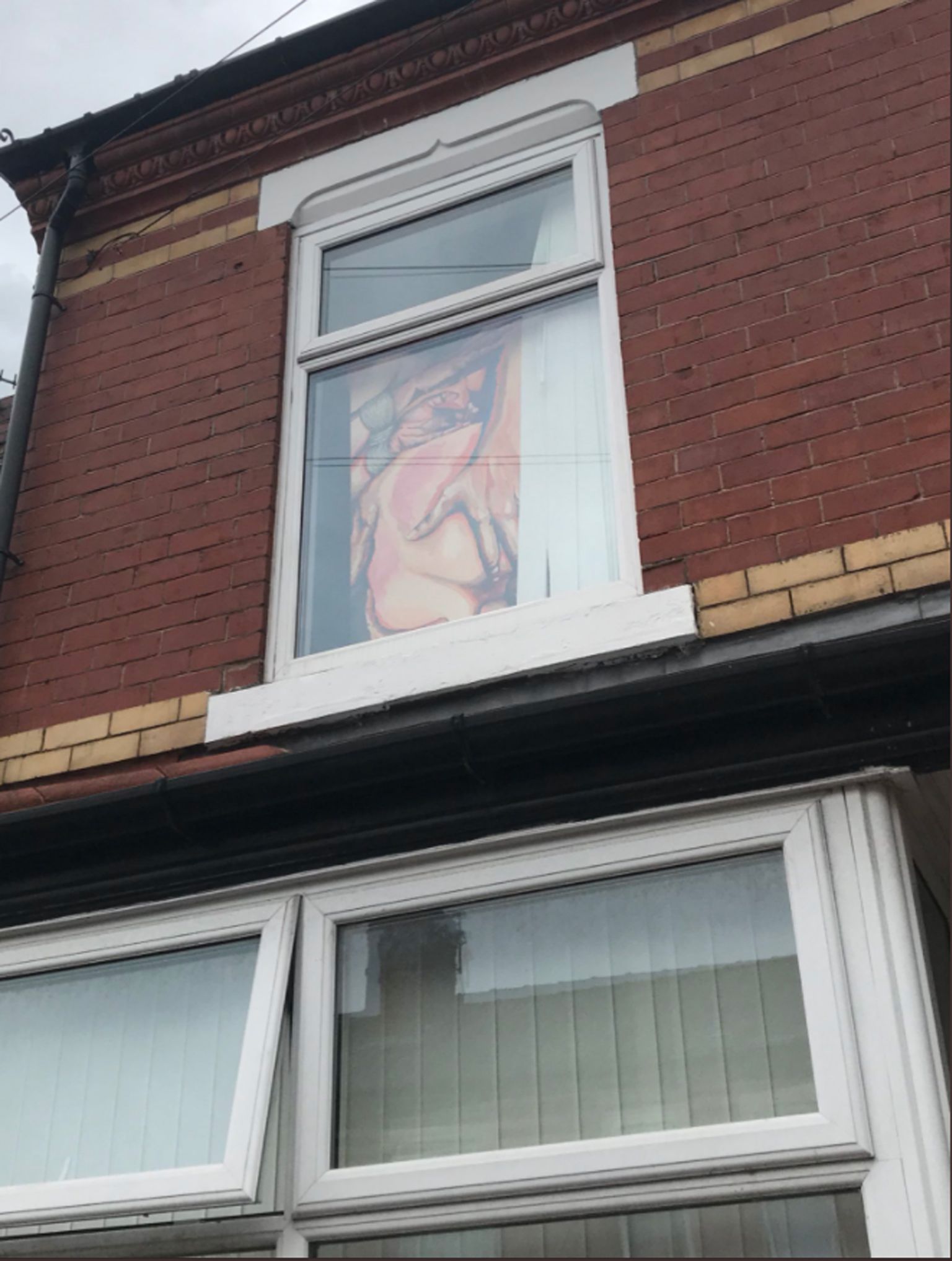 PIC FROM Caters News - (PICTURED: The pornographic painting up against ,Lucy Briscoe-Rimmers window in Salford, Manchester) - A festival go-er accidentally left a deeply offensive pornographic painting up against her window  leading to her entire street complaining about the phallic drawing.Lucy Briscoe-Rimmer, 20, a Visual Arts student painted Double an*l penetration as part of her second year project on pornography in art  but accidentally left it up against her window whilst she was at Boomtown festival.SEE CATERS COPY