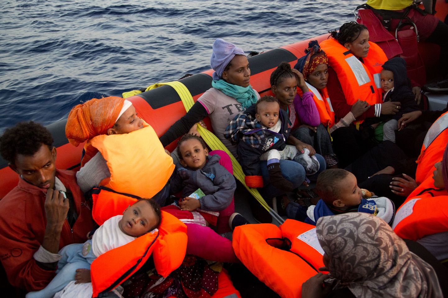 Migrants from Eritrea hold their children after been rescued from a crowded wooden boat as they were fleeing Libya, during a rescue operation in the Mediterranean sea, about 13 miles north of Sabratha, Libya, Monday, Aug. 29, 2016. Thousands of migrants and refugees were rescued Monday morning from more than 20 boats by members of Proactiva Open Arms NGO before transferring them to the Italian cost guards and others NGO vessels operating in the zone.(AP Photo/Emilio Morenatti)