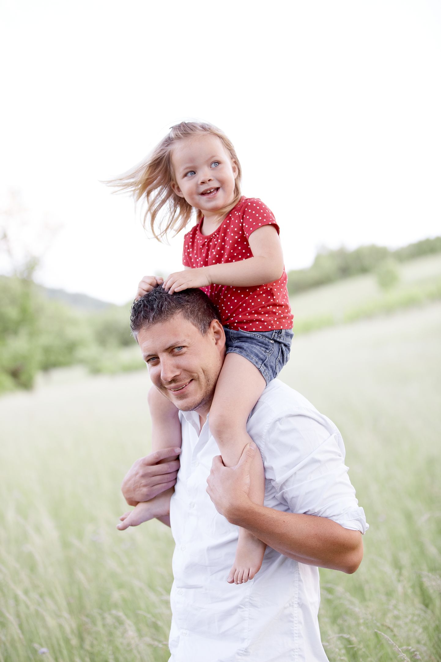 father with daughter in meadow