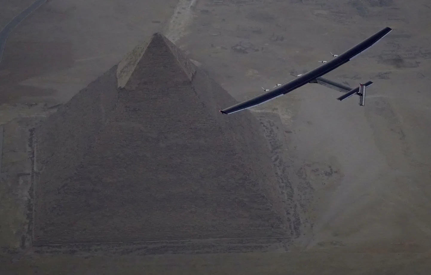 Solar Impulse 2, the solar powered plane, piloted by Swiss pioneer Andre Borschberg is seen during the flyover of the pyramids of Giza on July 13, 2016 prior to the landing in Cairo, Egypt in this photo released on July 13, 2016. Jean Revillard/SI2/Handout via Reuters ATTENTION EDITORS - THIS IMAGE WAS PROVIDED BY A THIRD PARTY. FOR EDITORIAL USE ONLY. NO RESALES. NO ARCHIVES.