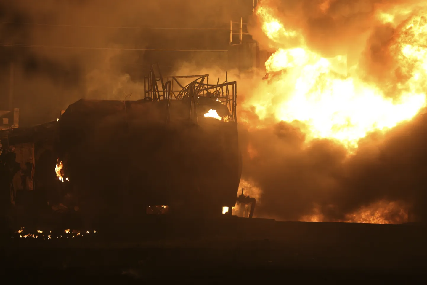 Fuel tanks burn after the shelling that Russian officials in Donetsk said was conducted by Ukrainian forces, at a fuel depot in Makiivka, outside Donetsk, Russian-controlled Donetsk region, eastern Ukraine, Wednesday, July 5, 2023. (AP Photo/Alexei Alexandrov)  XDL106