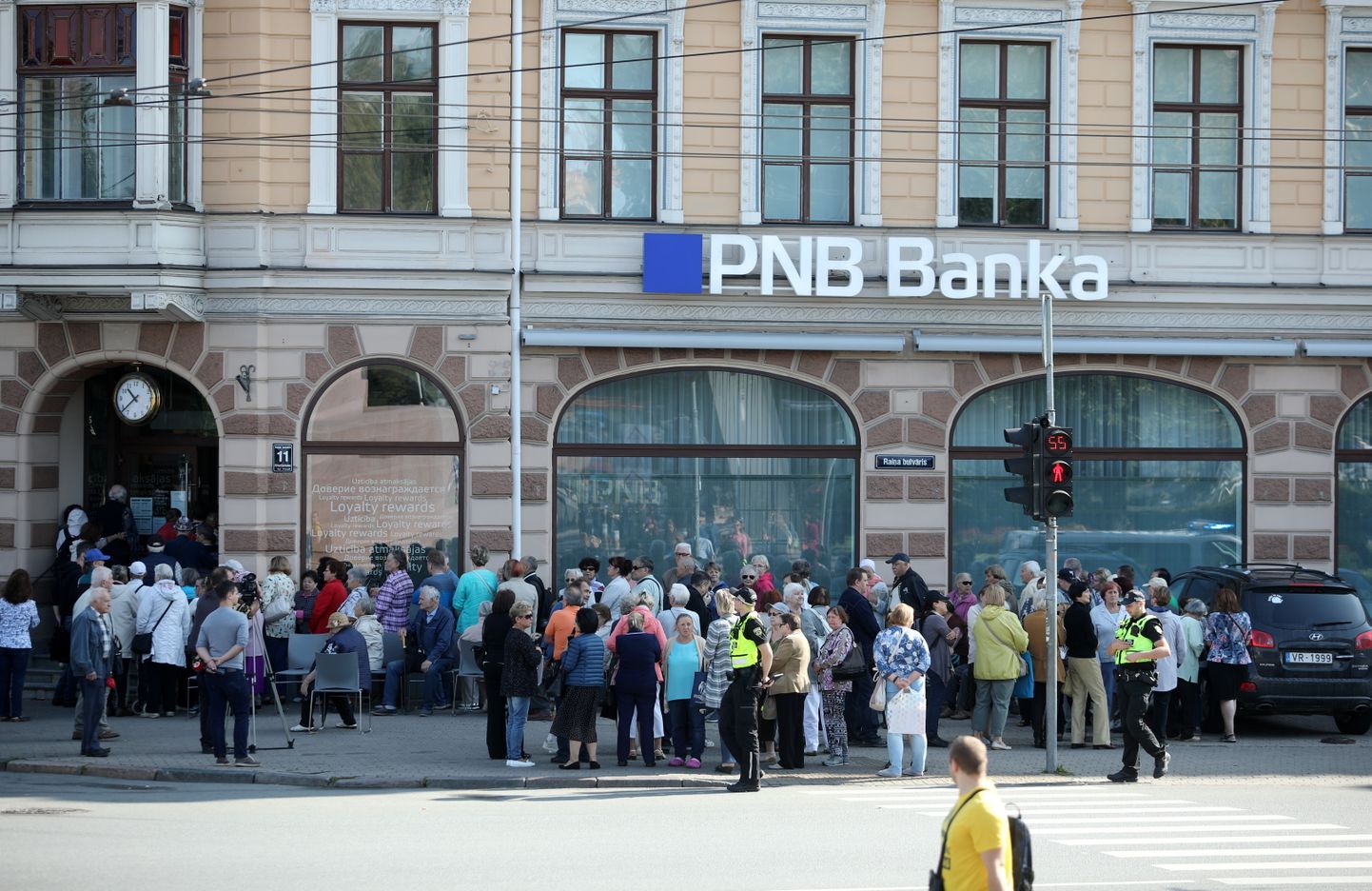 Sākoties garantēto atlīdzību izmaksām, "PNB Bankas" klienti gaida rindā pie bankas galvenās filiāles Raiņa bulvārī.