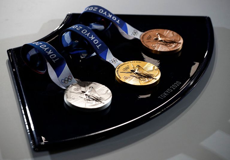 The medals and tray to be used for the medal ceremonies at the Tokyo 2020 Olympics Games are seen during an event to mark 50 days to the opening ceremony, at Ariake Arena in Tokyo on June 3, 2021. (Photo by ISSEI KATO / POOL / AFP)