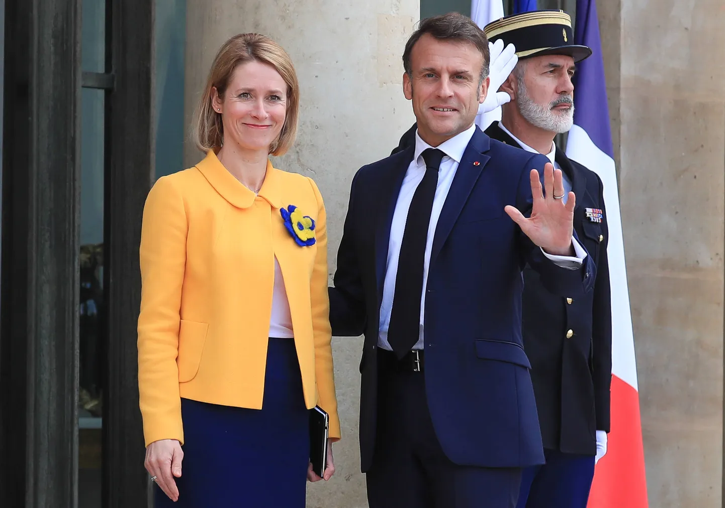 France's President Emmanuel Macron waves as he welcomes Estonia's Prime Minister Kaja Kallas for a meeting at the Elysee Palace in Paris.